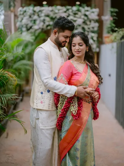 A gentle and poised portrait of Gayatri and Saurabh. The focus is on their connection, with their hands intertwined, symbolizing their union.