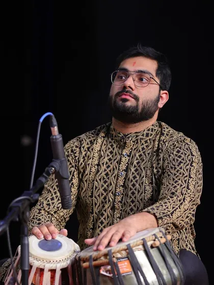 In a moment of deep focus during a performance. My goal is always to listen intently and respond to the main artist, creating a seamless rhythmic conversation on stage.