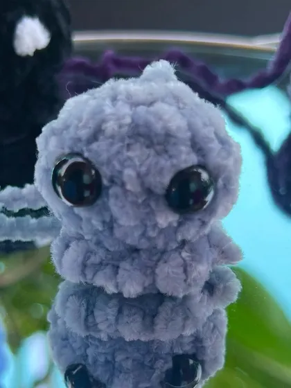 Here is the mini octopus keychain in a lovely periwinkle grey color, reflected on a mirror to show all its cuteness.