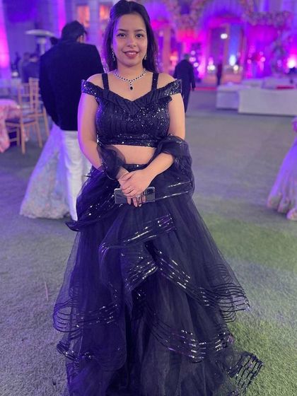 A fun and flirty black ruffled gown. This rental is perfect for a cocktail party or a bachelorette, offering a playful yet sophisticated look.