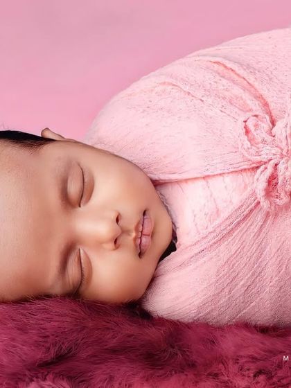 This angle shows the baby's profile, emphasizing their tiny nose and lips.
