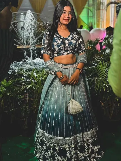 Our client looks beautiful in this blue ombre lehenga. The dark floral blouse and the lighter skirt create a stunning contrast, perfect for an evening event.