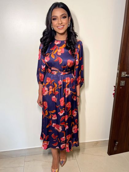 The full look for a festive brunch. The floral dress is paired with simple, elegant makeup that lets her natural beauty shine.