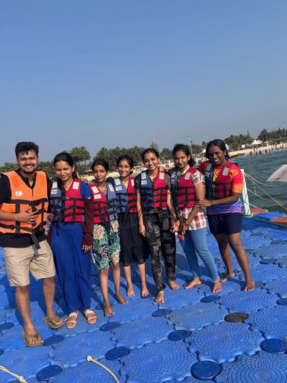 Having fun on the floating sea bridge at Malpe beach, a popular attraction.