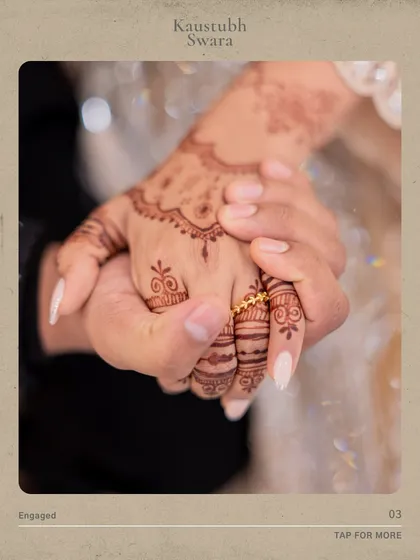 A close-up shot focusing on the bride's hand, adorned with mehndi and her new engagement ring, held by her fiancé.