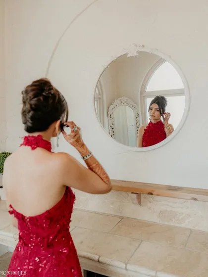 A quiet moment of preparation for the bride, Shifa. The reflection in the mirror adds a layer of introspection to this classic getting-ready shot.