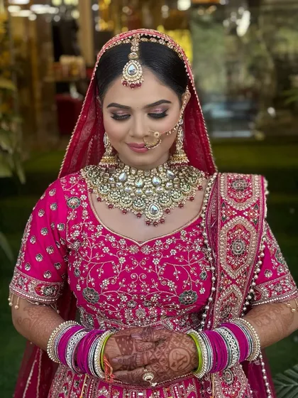 A close-up showcasing the soft, shimmery eye makeup on this beautiful bride. The pink tones in the eyeshadow perfectly match her lehenga, creating a harmonious and elegant look.