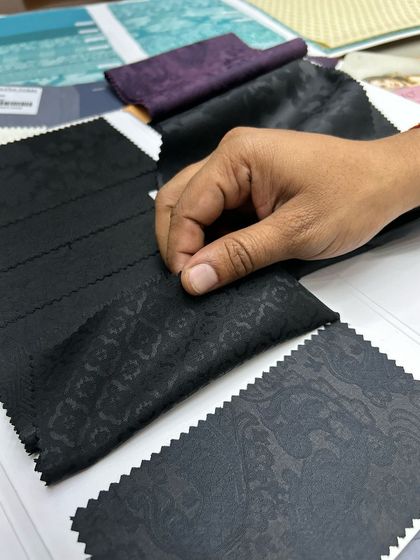 Our designer exploring different black jacquard options for a client's custom piece.