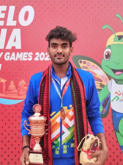 Maan Kesarwani holds his bronze medal and trophy, representing his university at the Khelo India University Games in Guwahati.