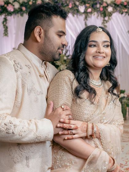 A gentle embrace filled with smiles and affection. This candid shot captures the couple's deep bond and happiness during their engagement ceremony.