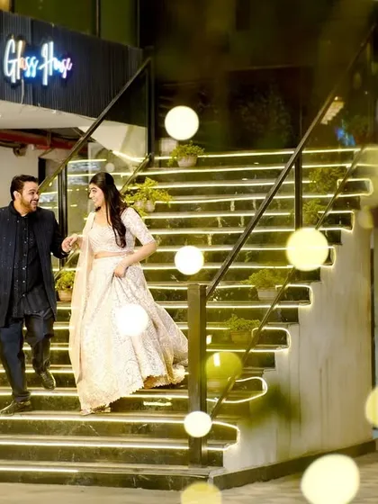 A candid shot of the couple making their entrance, with creative use of foreground bokeh for an artistic effect.
