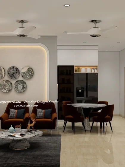 This living and dining space combines modern furniture with artistic wall decor. The dark, comfortable armchairs create a cozy conversation corner, while the plate-like wall art adds a unique touch.