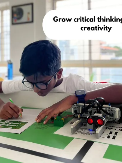 Our goal is to foster critical thinking and creativity that lasts a lifetime. This student is deeply focused on planning his robot's strategy for the Indian Robotics Olympiad, a perfect example of the problem-solving mindset we cultivate.