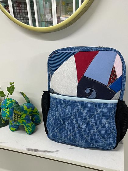 The upcycled backpack displayed next to a matching stuffed toy, showing how leftover fabric can be used creatively.