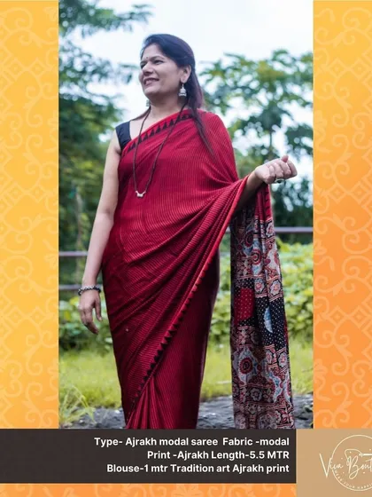 A full view of our customer wearing a beautiful red Ajrakh modal saree. The detailed pallu with its mix of colors and patterns is the highlight of this piece.