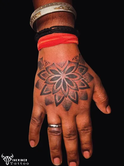 This geometric mandala tattoo was designed to cover up a previous tattoo on the back of the hand. The intricate dot work and symmetrical patterns create a bold and clean look, demonstrating how geometric designs can be perfect for cover-ups.