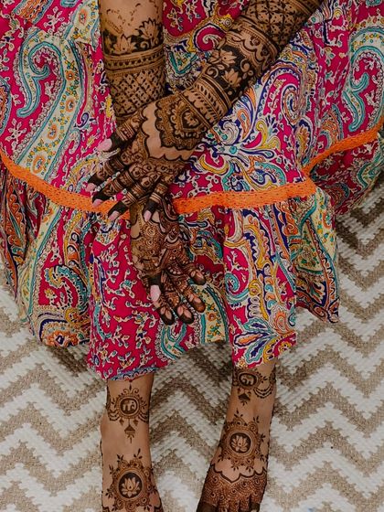 A complete look showing the minimal foot design paired with intricate hand mehendi, creating a balanced look.