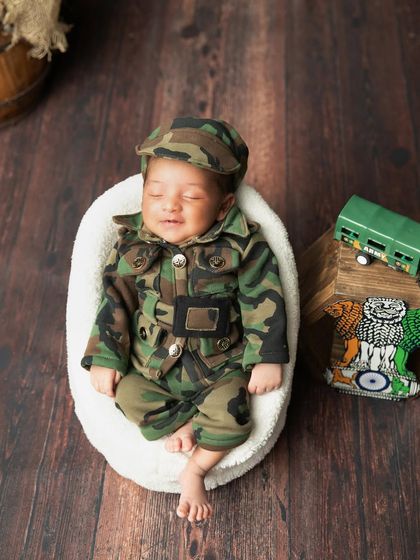 A happy little soldier with a sleepy smile. These moments are pure gold.