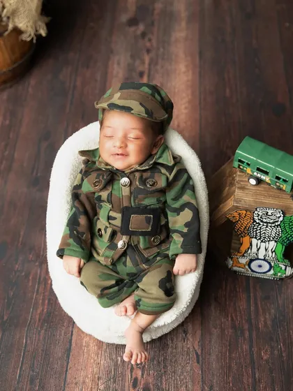 A happy little soldier with a sleepy smile. These moments are pure gold.