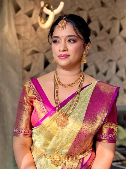 This shot captures the bride in a moment of quiet elegance. The makeup looks soft and radiant in the natural light.