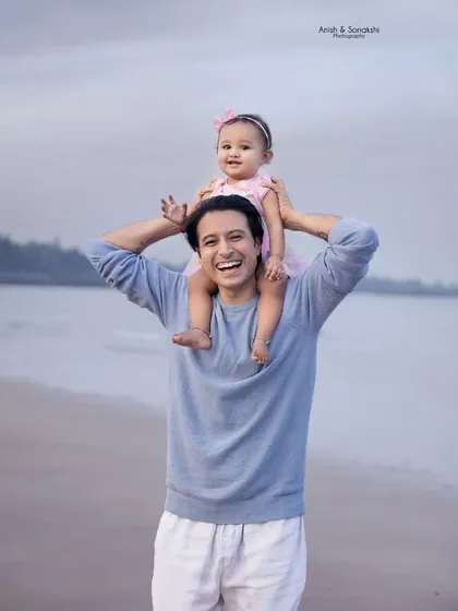 There's nothing like the love a father has for his little girl. This beautiful beach portrait captures a moment of pure joy and connection.