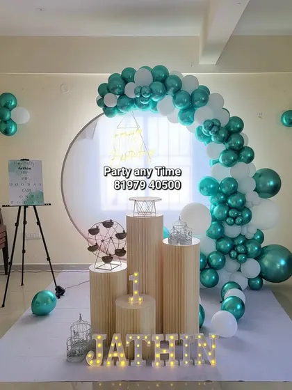 Another view of the teal and white first birthday setup, highlighting the clean and modern look.