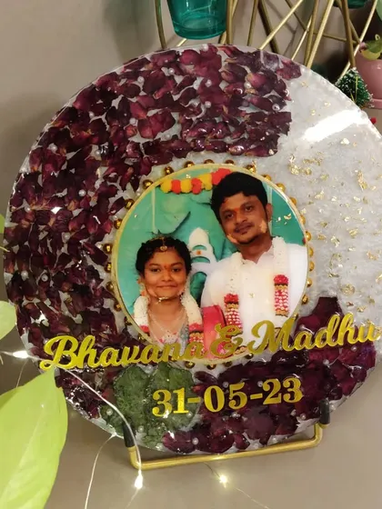 Here is a beautiful circular resin frame preserving a couple's varmala flowers. I added their photo, names, and wedding date to make it a truly personal piece of decor for their home.