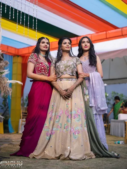The bride and her bridesmaids striking a pose. Each makeup look was tailored to the individual while keeping a consistent theme of soft, glowing beauty.