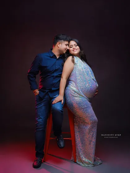 A chic and modern couple's portrait. The mother-to-be shines in a sequined gown, creating a glamorous look perfect for celebrating this special time.