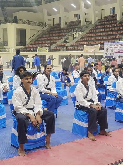 Our junior athletes waiting for their turn to compete at the Junior National Taekwondo Championship. Mental preparation and focus are key aspects of our training.