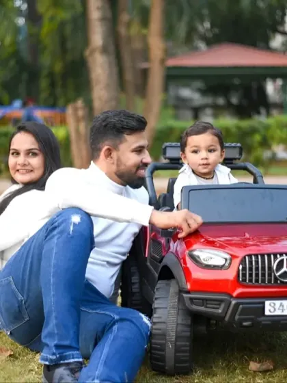 A perfect family moment captured outdoors. I focus on natural interactions to create relaxed and happy family portraits, like this one with parents and their little one enjoying a day in the park with his new toy car.