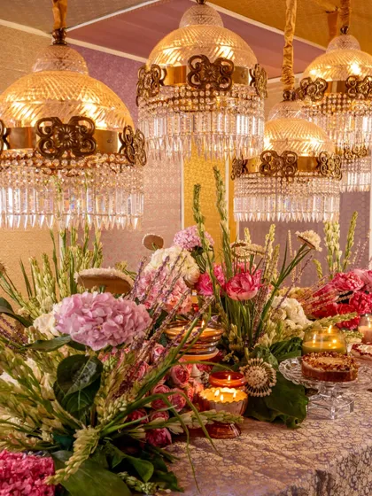 A closer look at the opulent 'Rituals' tablescape. You can see my iridescent Scented Utopia candles adding a modern touch to the traditional floral arrangements and magnificent lighting.