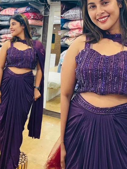 This purple drape saree with a heavily sequenced blouse is a glamorous choice for any party.