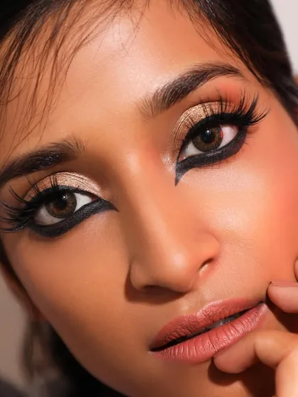 A dramatic and intense eye makeup look from our archives. The bold, graphic kohl liner paired with gold shimmer is perfect for a glamorous evening event.