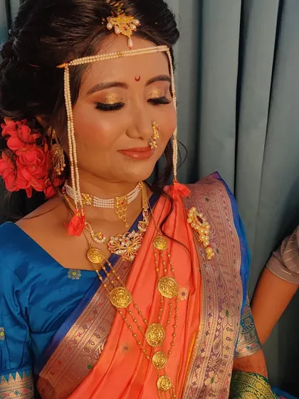 A close-up showing the delicate 'mundavalya' and the layered gold necklaces, essential parts of the Marathi bridal attire.