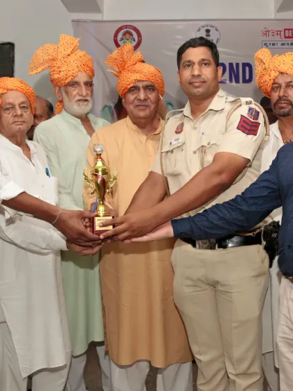 Presenting a trophy to a winner at a championship event. Recognizing talent and hard work is part of our culture.