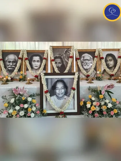The altar at our Kriyaban retreat, adorned with garlands. In the foreground is a portrait of Daya Mata, a great disciple of Yogananda, honoring the entire spiritual family.