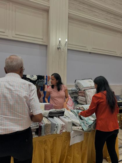 Shoppers browsing through a wide selection of home linens and textiles. I encourage vendors to bring a diverse range to appeal to more customers.