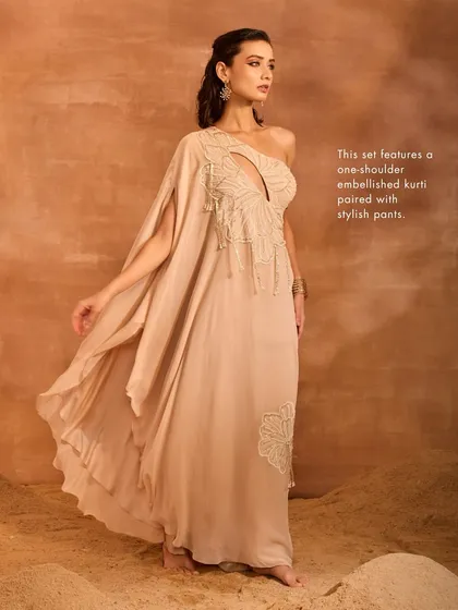 The Talia Kurti Set in motion, with its one-shoulder drape flowing gracefully. This set features an embellished kurti paired with stylish pants.
