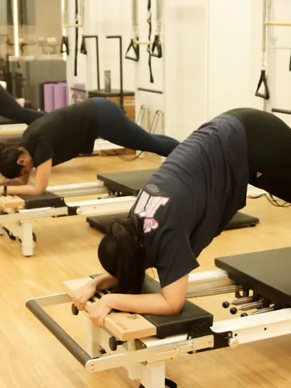 Another angle of the reformer plank, showing the focus and determination of the class as they work together to build core endurance.