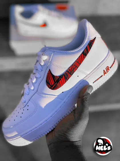 A hand-held shot of the MotoGP custom sneaker, showing off the full design.