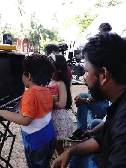 A sweet moment on set where the child actors are curiously watching the playback on the monitor with the director.