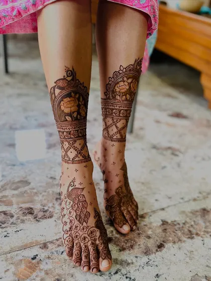 I believe mehndi should adorn you from head to toe. This traditional foot design features majestic peacocks and delicate jaali net patterns, ensuring your feet look as stunning as your hands for any festive occasion.