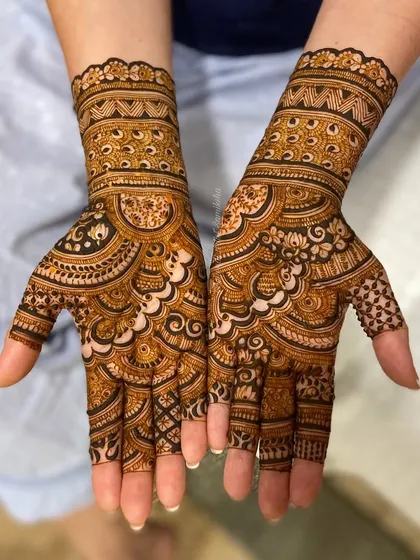 A finished design shown in steps, starting with a simple cuff and building into a full, intricate hand design.