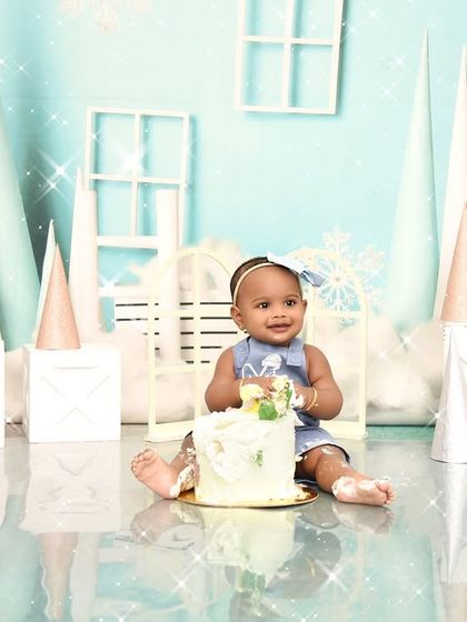 A sweet cake smash moment from a winter wonderland themed shoot. The simple joy of digging into a cake is a memory every parent treasures.