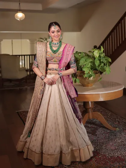 The bride looks happy and confident in this unique ensemble, which perfectly blends traditional crafts with a modern silhouette.