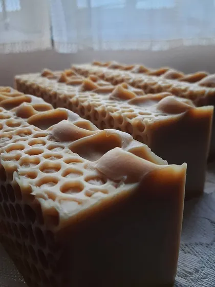 Three loaves of my Goatmilk, Oats, and Honey soap, showing off their textured tops. This bar is packed with colloidal oatmeal and creamy goat's milk, making it my go-to for soothing irritated or dry skin.