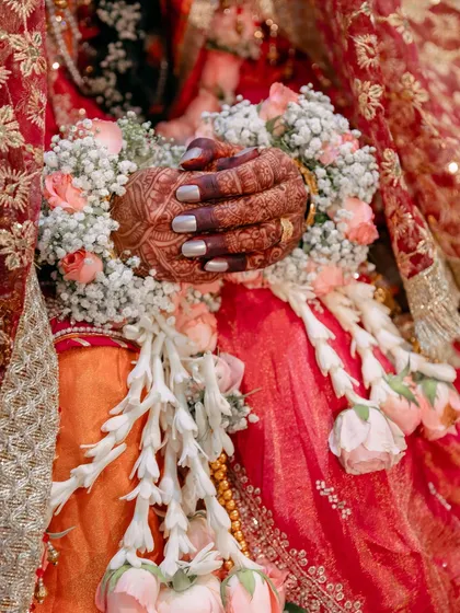 The beauty is in the details. This close-up from a Muslim wedding highlights the intricate henna, floral garlands, and traditional attire that make each celebration unique.