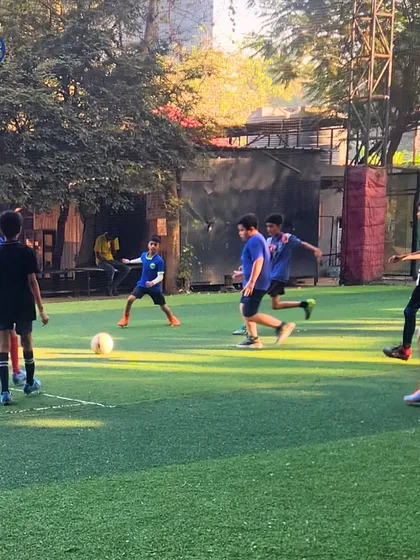 Young footballers engaged in a practice match on an artificial turf. This action shot captures the intensity and focus of our athletes as they learn to play as a cohesive unit.
