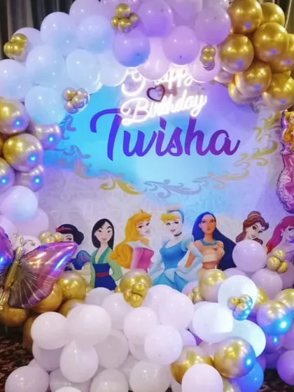 A Disney Princess theme perfect for your little one. This setup features a custom backdrop with various princesses, surrounded by white and gold balloons and a personalized neon sign.
